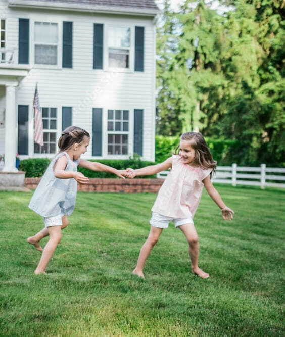 Two young girls playing in a pest free yard